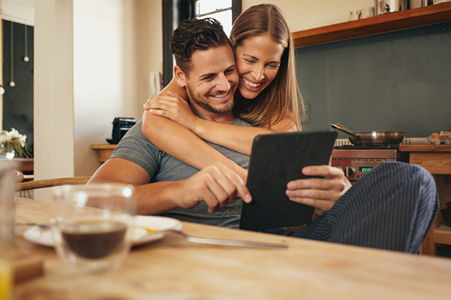 two couples checking something on their ipad and enjoying the moments together