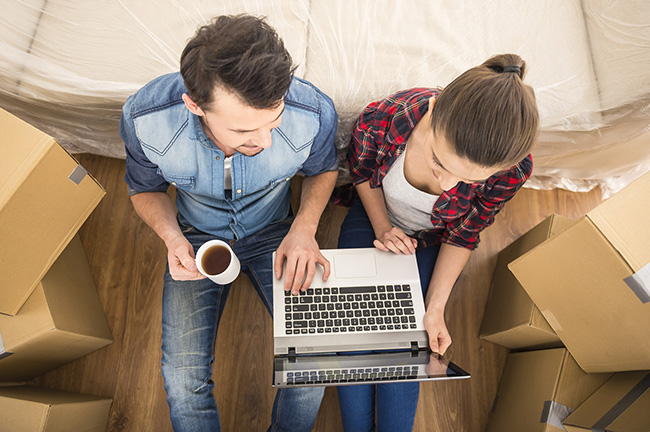 two couples checking something on their computer